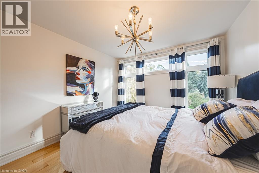 Bedroom featuring wood finished floors and a chandelier