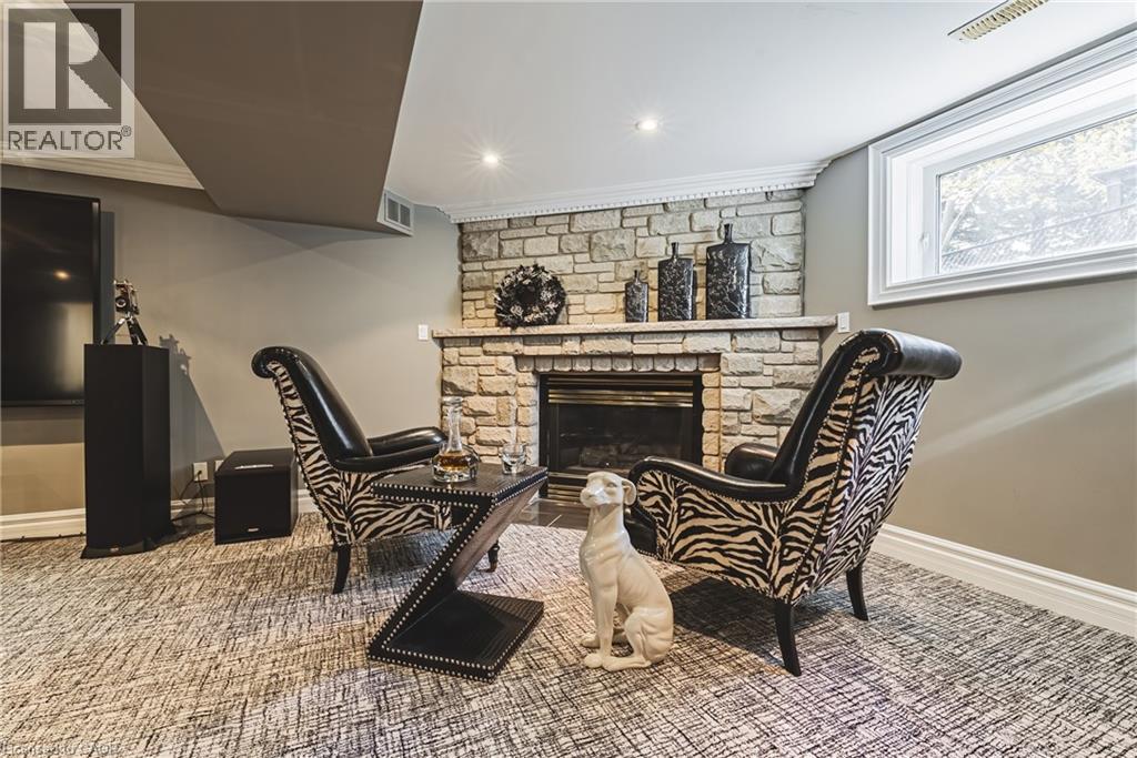 Sitting room featuring a stone fireplace, crown molding, recessed lighting, and carpet flooring