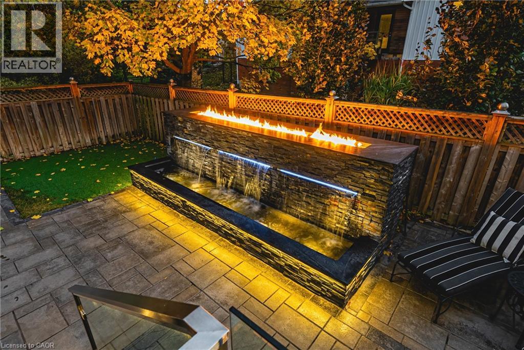 Fenced backyard featuring an outdoor fire pit and a patio area