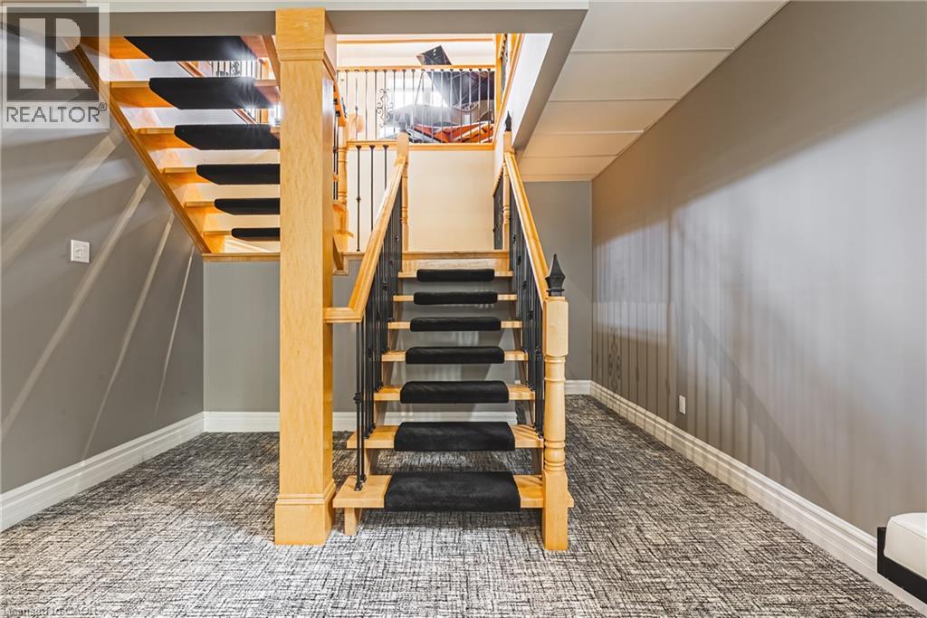 Staircase featuring carpet and baseboards