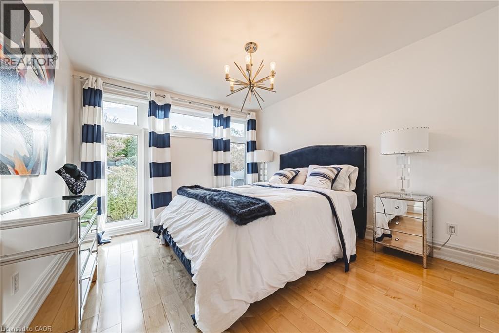 Bedroom featuring light wood-style flooring and a chandelier