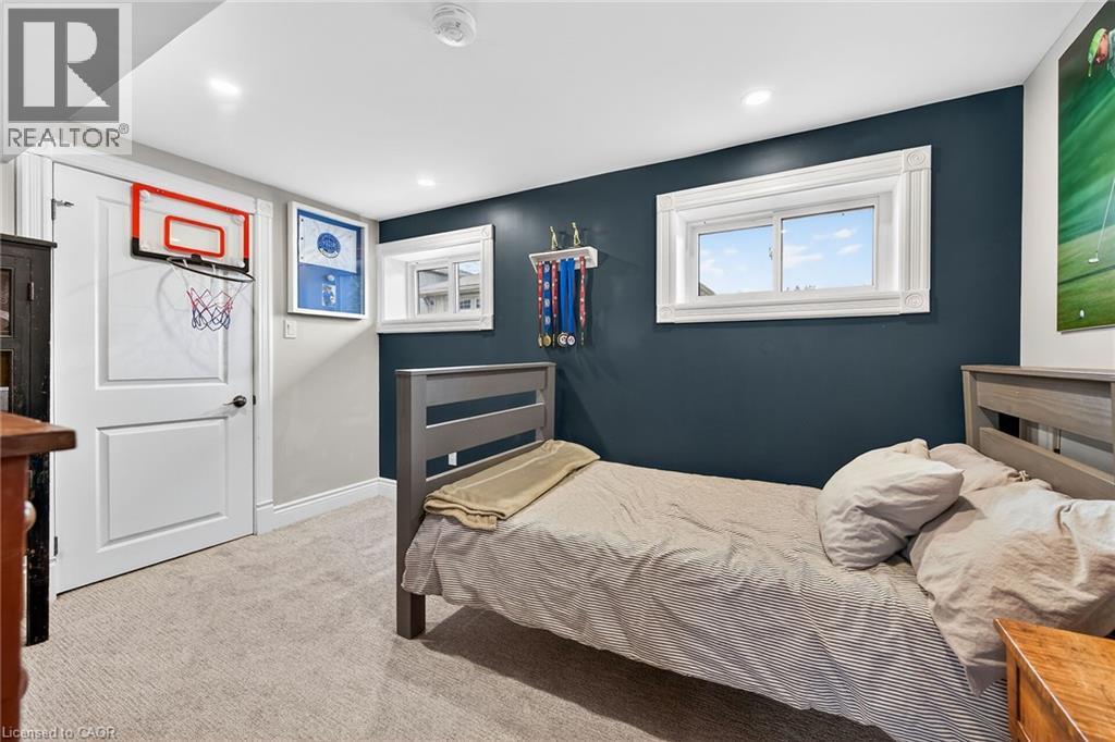 Bedroom with light colored carpet and recessed lighting