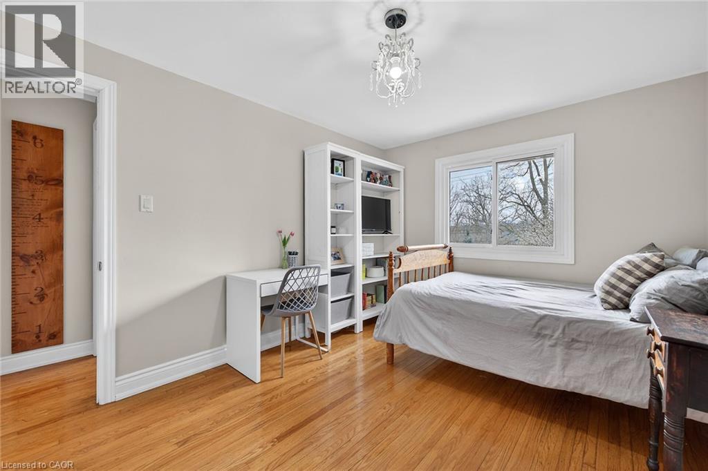 Bedroom featuring light wood finished floors and suspended lighting