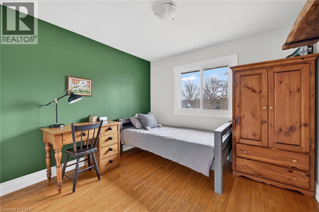 Bedroom with light wood-style floors and baseboards