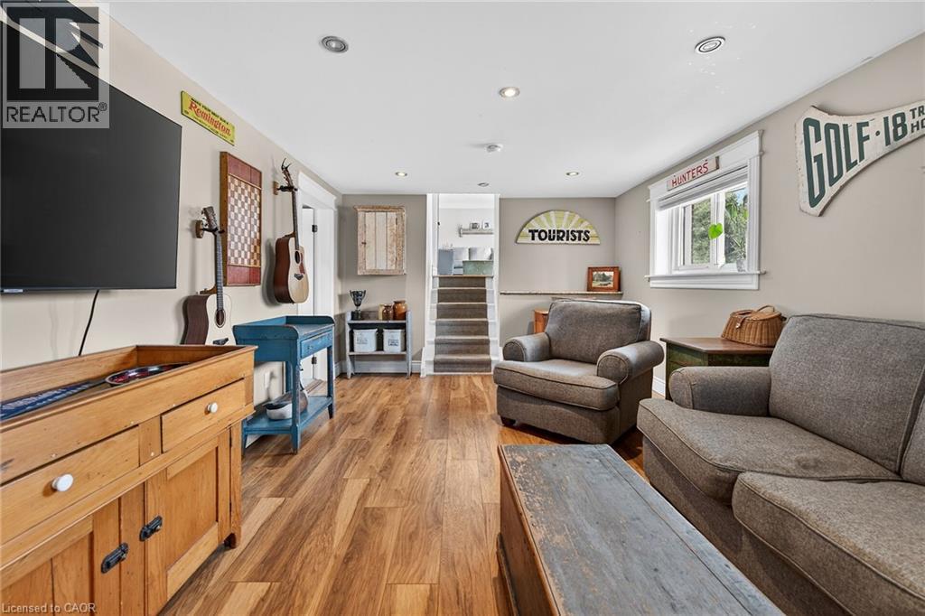 Living room with light wood-style flooring and recessed lighting