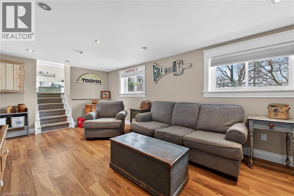 Living room with light wood-style floors and recessed lighting