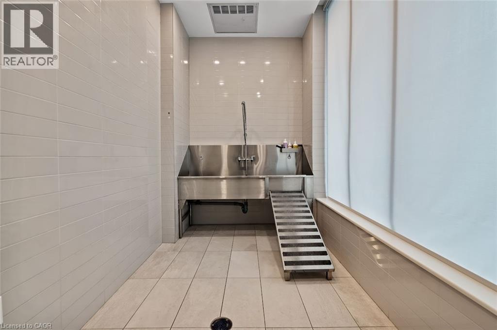 Misc room featuring pet washing station and light tile patterned flooring