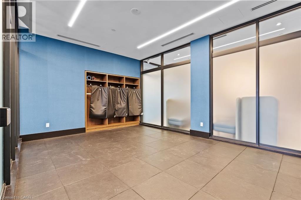 Empty room featuring baseboards and dark tile patterned floors