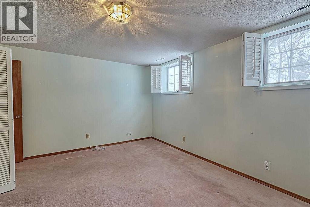 Single Family House Bi-level for Sale in  Woodland Crescent SE Willow Park Calgary 