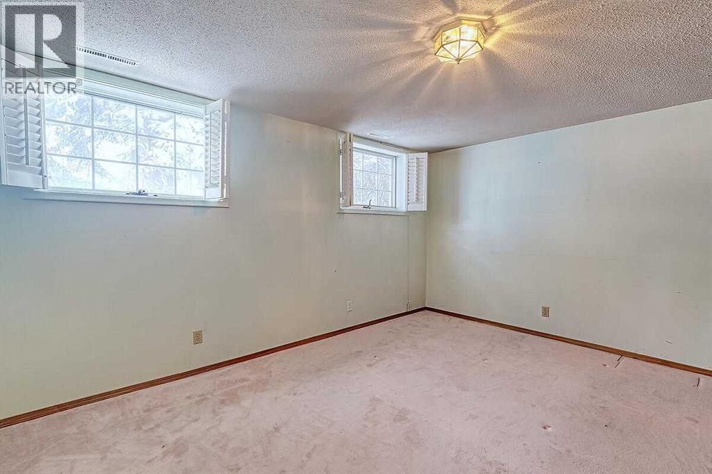 Single Family House Bi-level for Sale in  Woodland Crescent SE Willow Park Calgary 