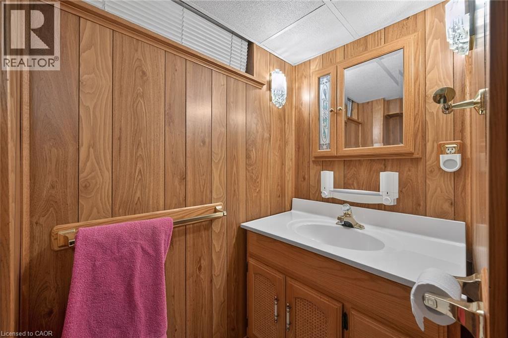 Bathroom with vanity and wood walls