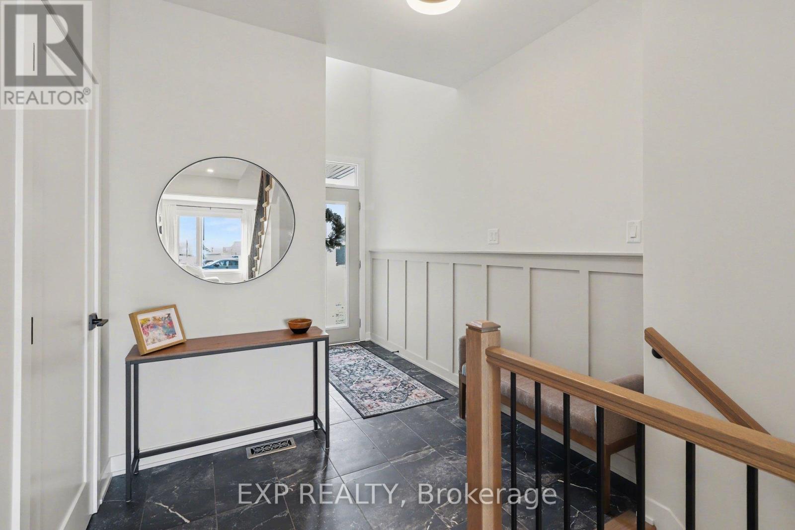 Foyer with upgraded 24\" tiles & custom panelling.
