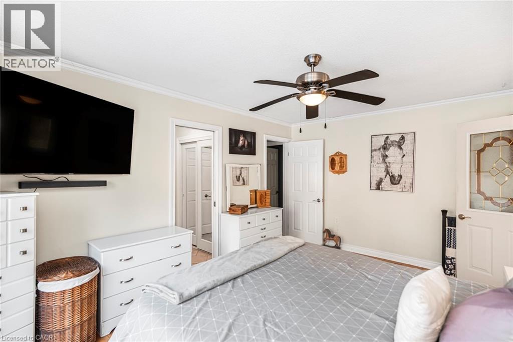 Bedroom with ornamental molding and ceiling fan