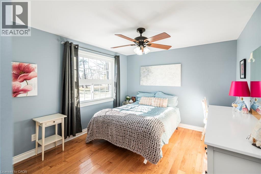 Bedroom with light wood-type flooring and a ceiling fan
