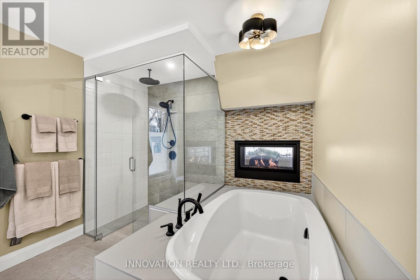 Primary ensuite with soaker tub and gas fireplace