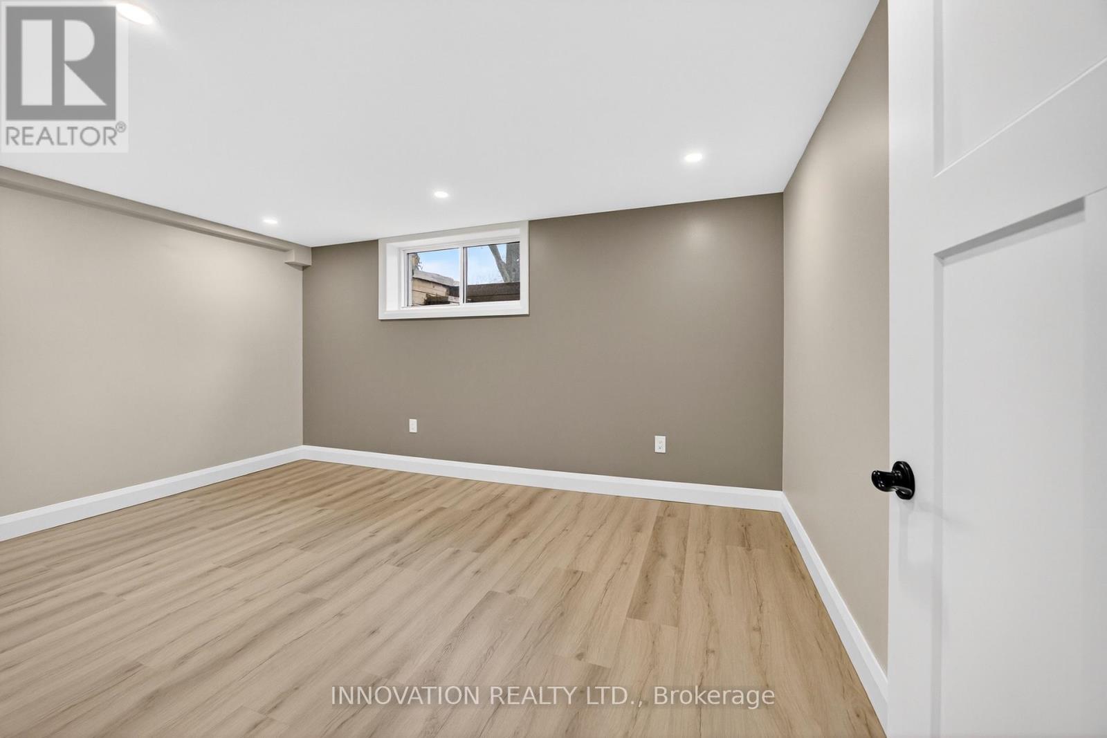 Fourth bedroom with large window and potlights