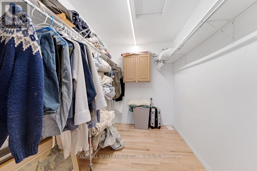 Walk-in closet, two walls of clothes hanging rods