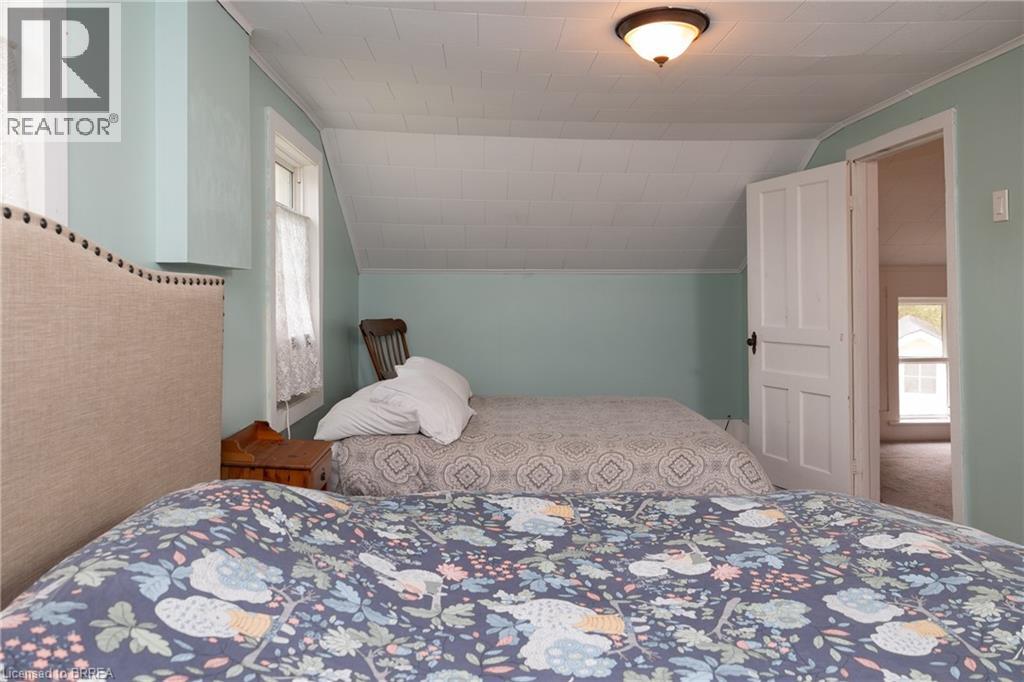 Bedroom featuring multiple windows and lofted ceiling