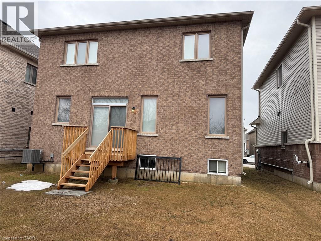 Back of property featuring brick siding