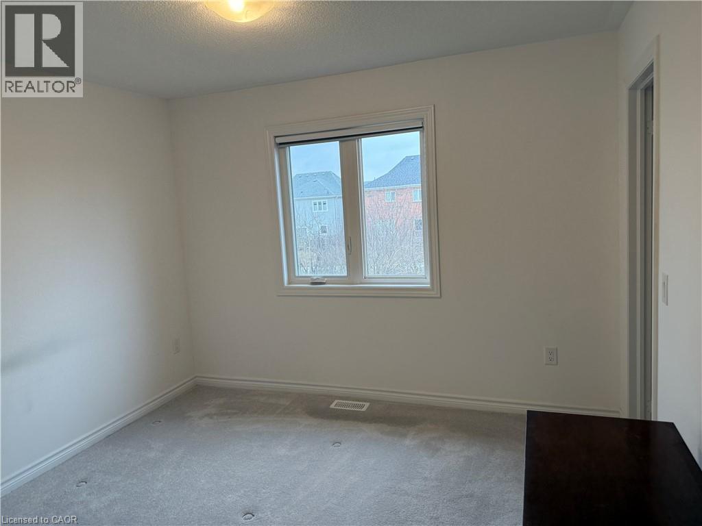 Carpeted empty room featuring baseboards and a textured ceiling