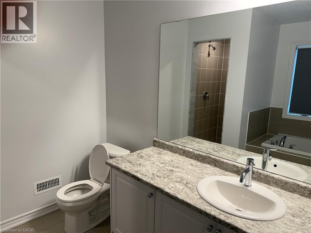 Bathroom with a bath, a shower stall, vanity, and light tile patterned floors