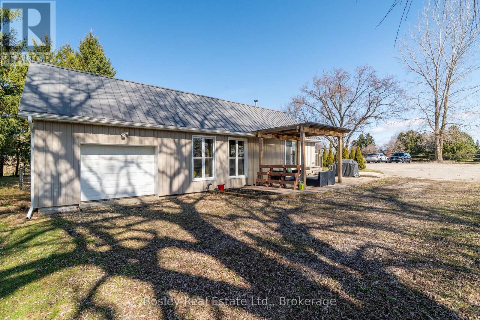 Front of pool house with single garage