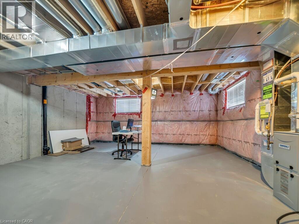 Below grade area with heating unit and healthy amount of natural light
