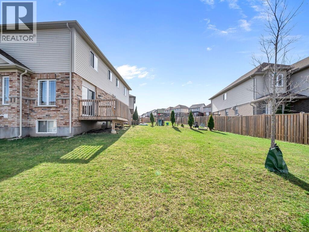 Fenced yard featuring a residential view and a wooden deck
