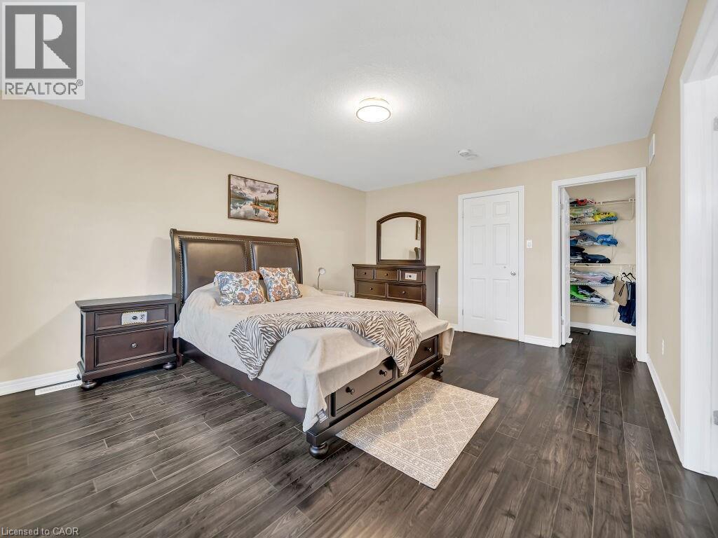 Bedroom featuring dark wood-style floors and a spacious closet