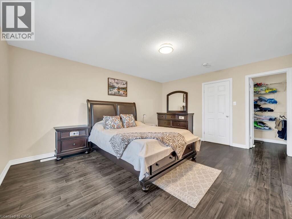 Bedroom with dark wood finished floors and baseboards