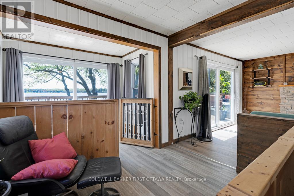 Den open to sitting nook with patio doors to deck
