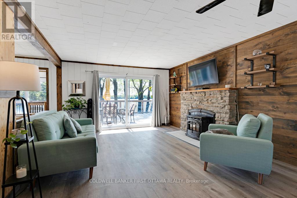 Livingroom stone fireplace has pellet-stove insert