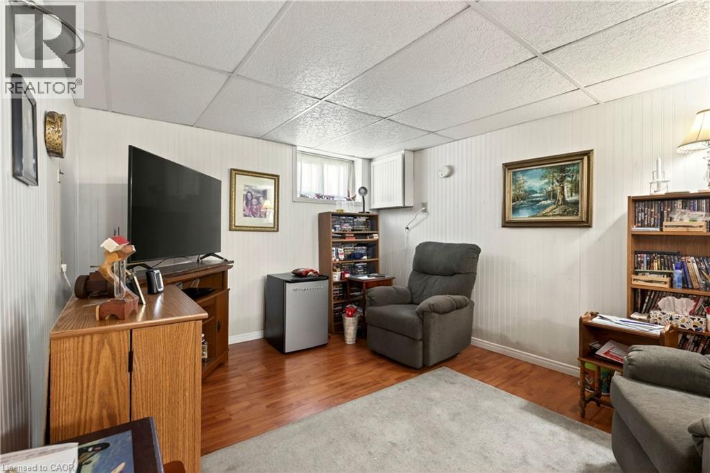 Living room with a drop ceiling and wood finished floors