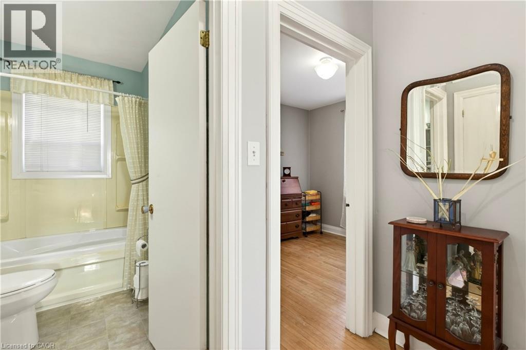 Bathroom featuring toilet and shower / bath combo with shower curtain