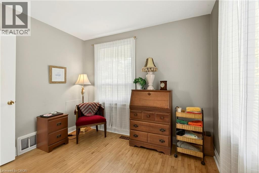 Sitting room featuring light wood-style flooring and baseboards