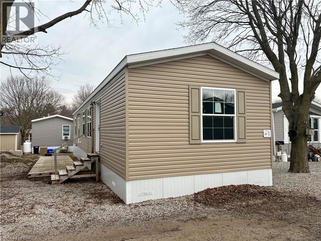 View of side of home featuring a storage unit