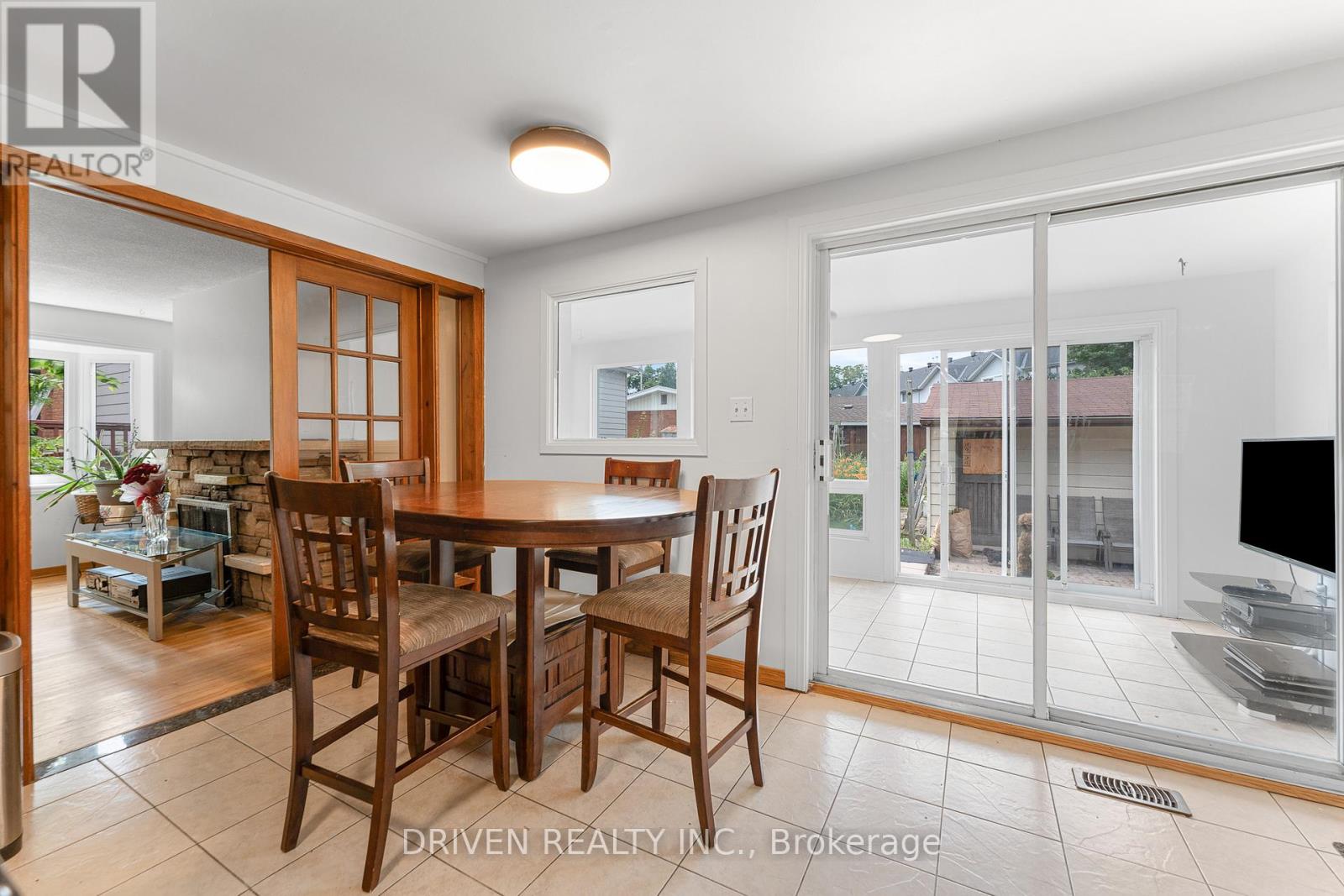 Eating space leading into sun-filled bonus room.