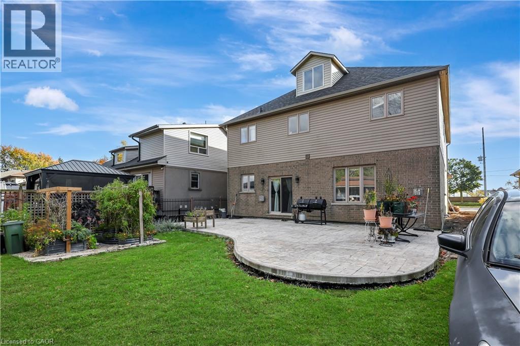 Back of property featuring brick siding and a patio area