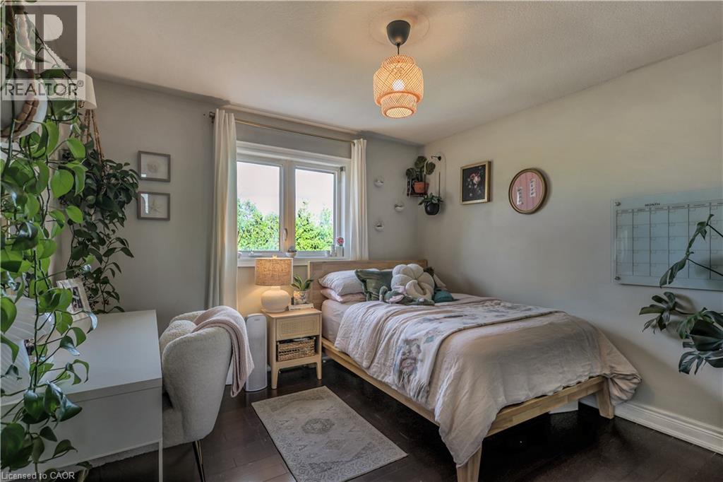 Bedroom featuring wood finished floors and baseboards