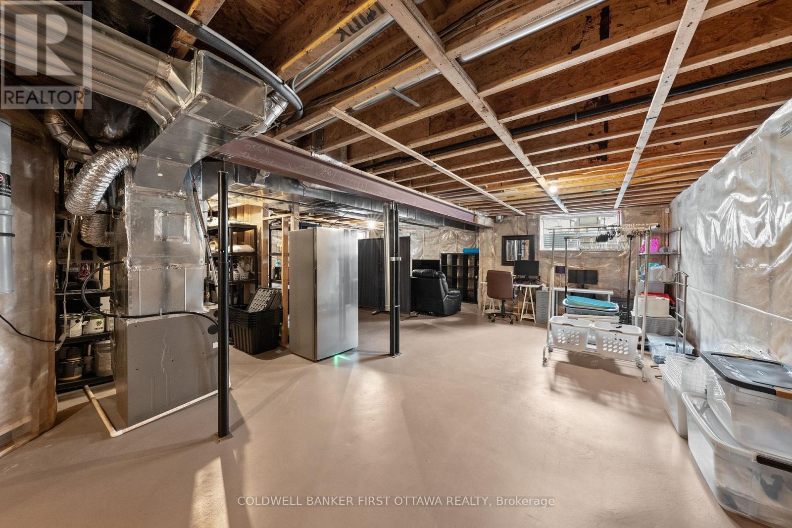 Unfinished clean & tidy basement space.