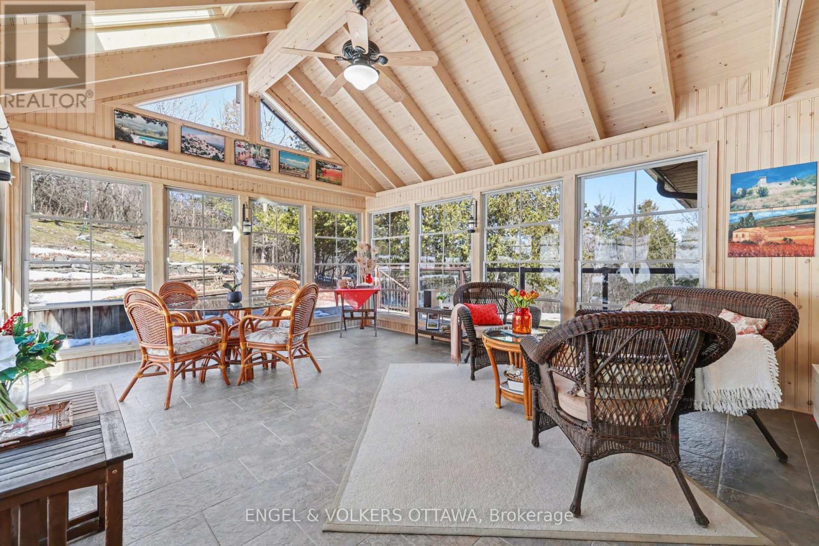 Gorgeous heated sunroom with wraparound decking
