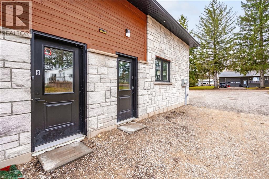 Doorway to property featuring stone siding
