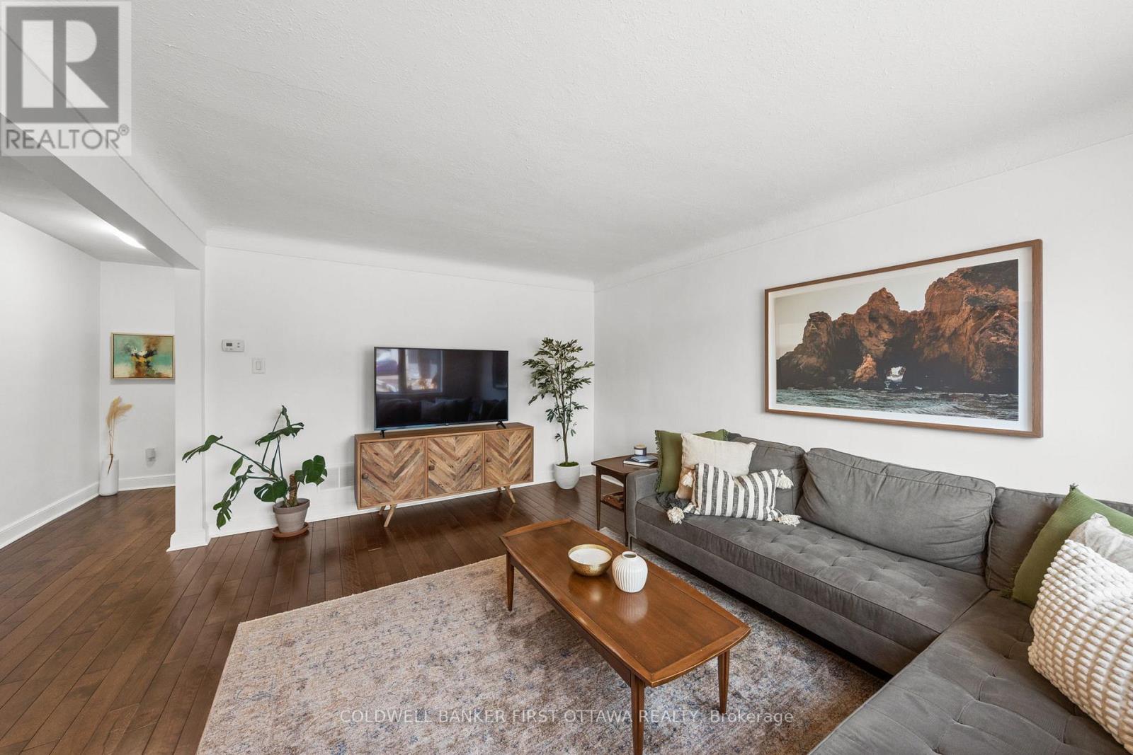 Expansive living room w bright front window.