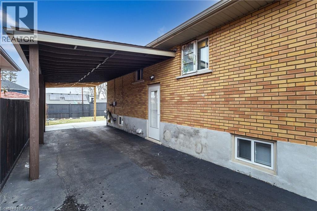 View of side of home with a carport and brick siding