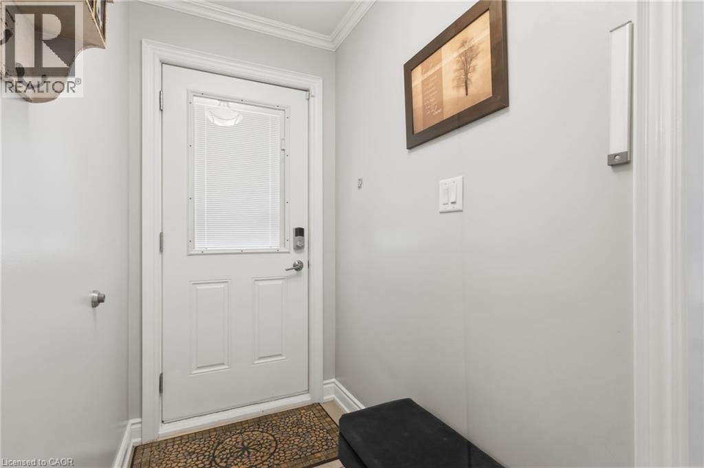 Doorway with ornamental molding and baseboards