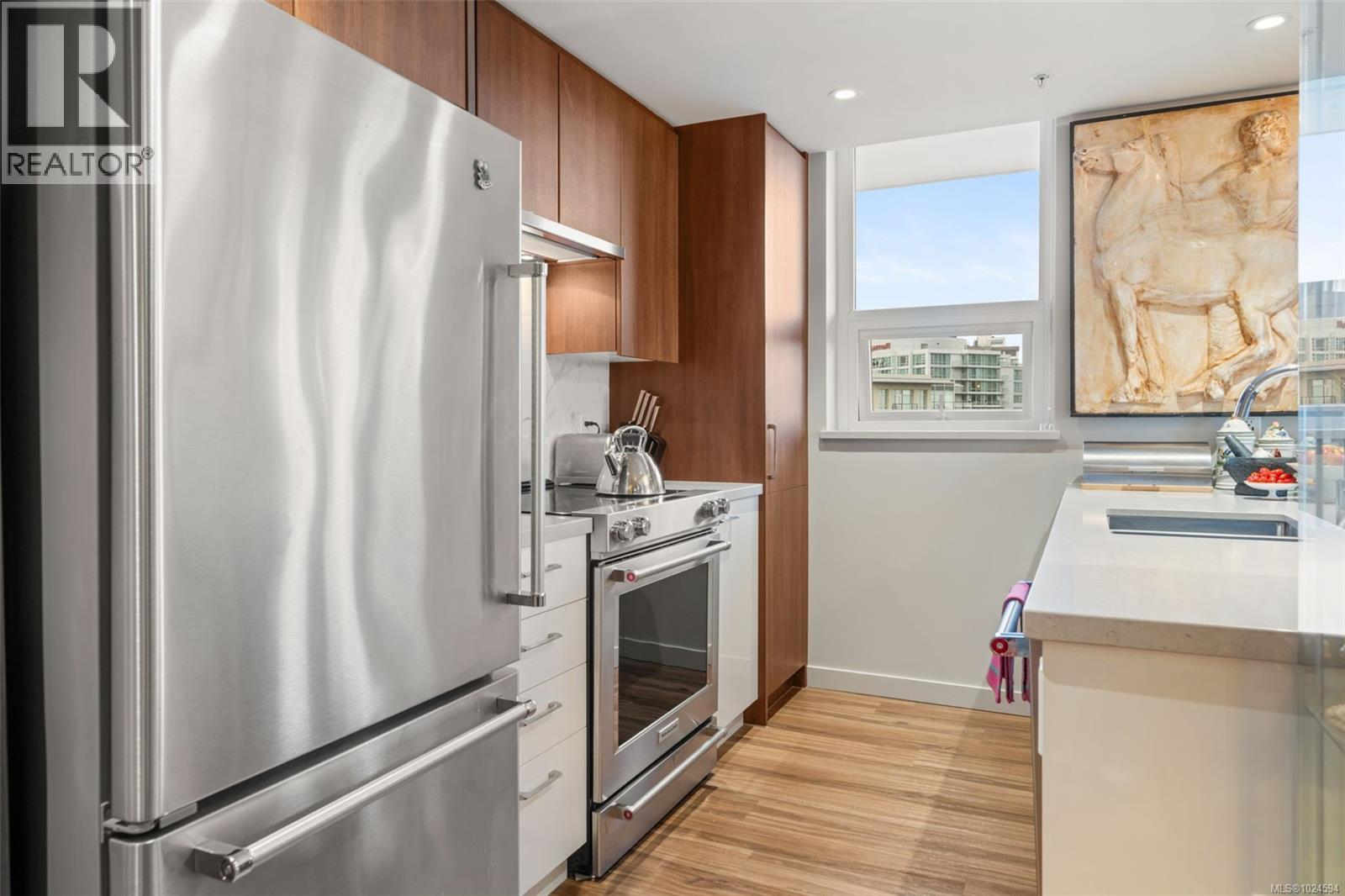 Kitchen with stainless appliances, modern cabinets and island