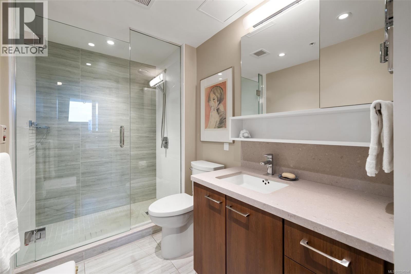 Primary Ensuite bathroom with vanity and walk-in shower.