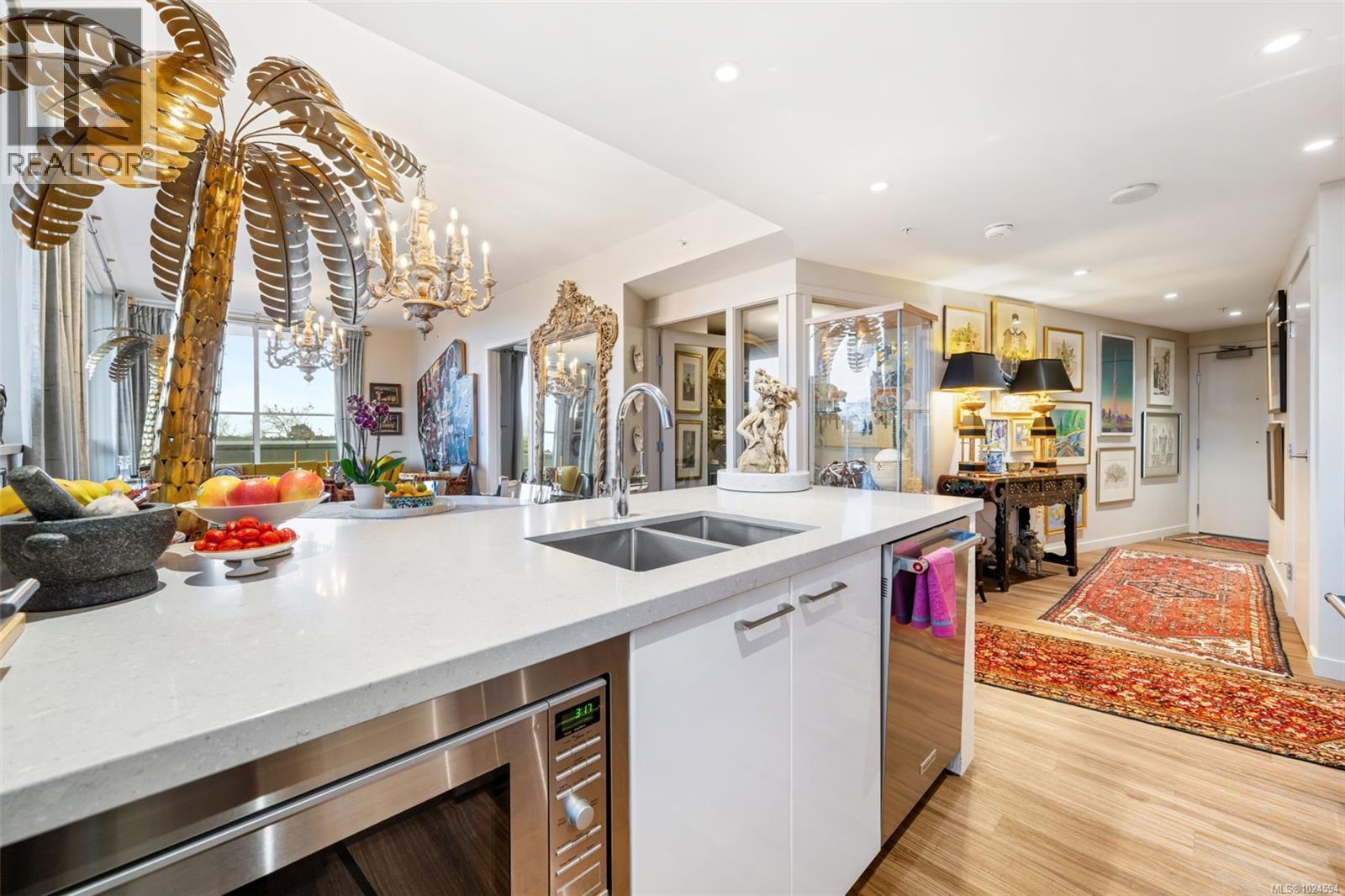 Kitchen with stainless appliances, modern cabinets and island