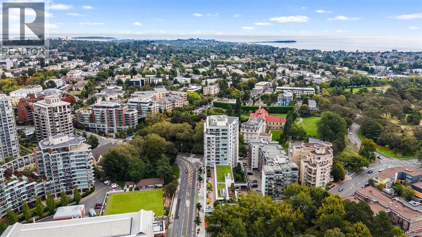 Aerial view of property's location with a large body of water and nearby urban area