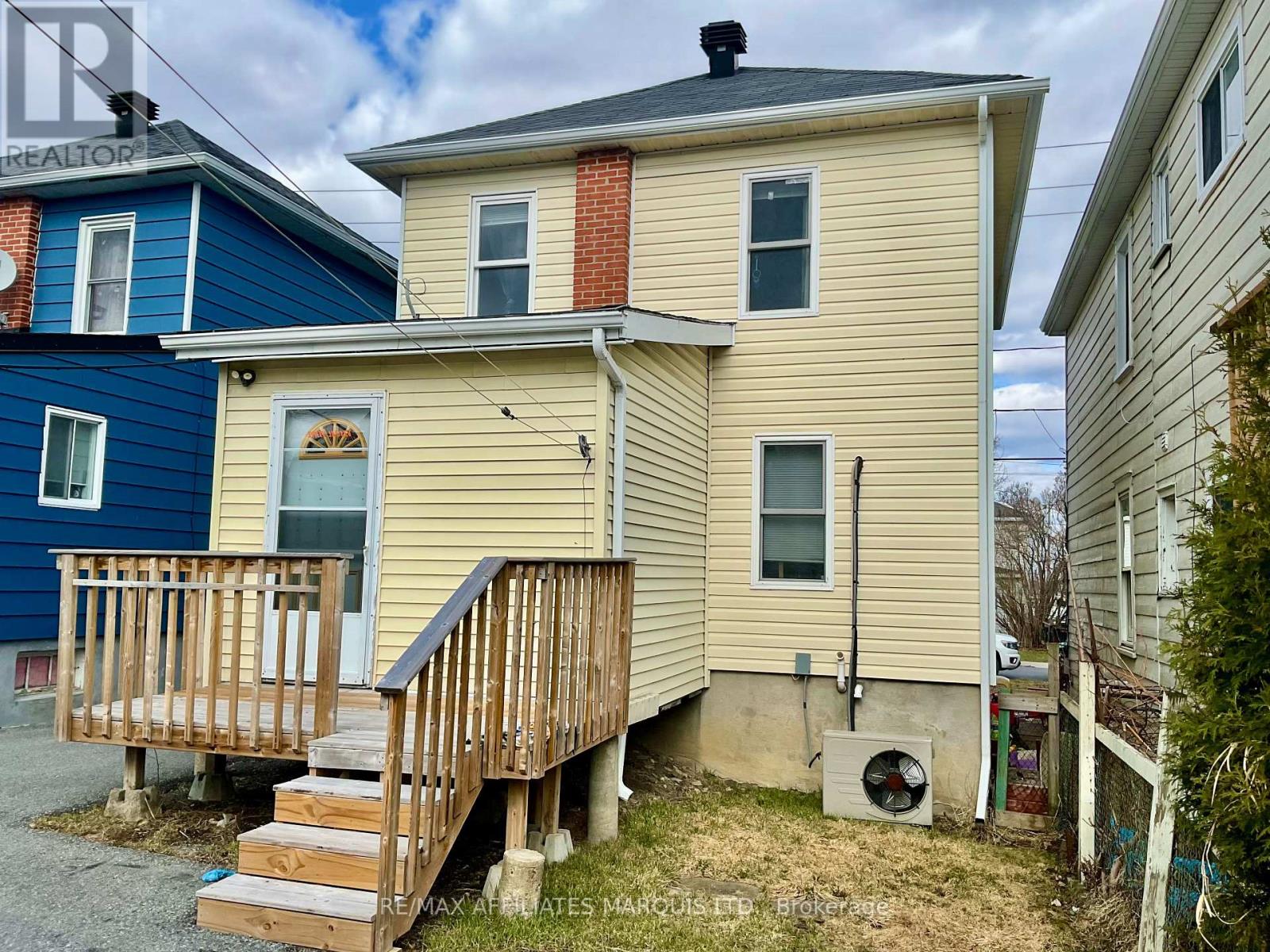 Back of house with enclosed porch & deck